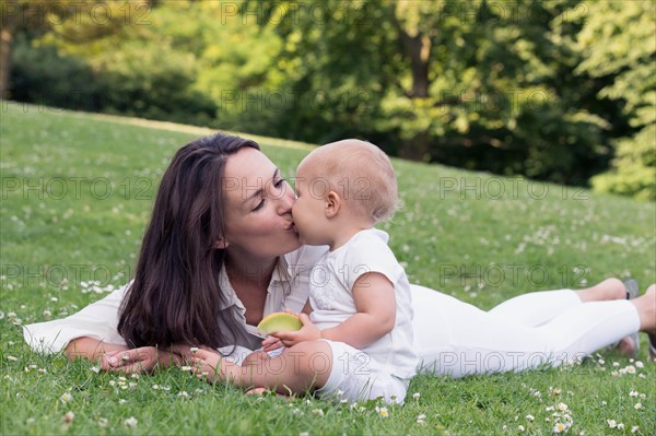 Mother and daughter (12-17 months) playing in park