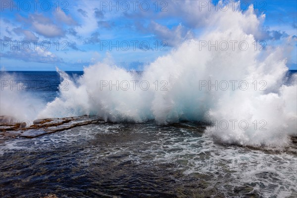 Wave crushing on rock