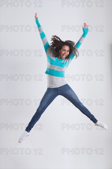 Studio Shot of girl (12-13) jumping