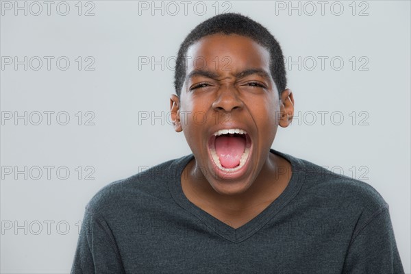 Portrait of teenage boy (14-15) shouting