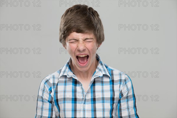 Portrait of teenage boy (14-15) shouting
