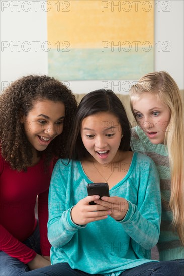 Girls (12-13,14-15,16-17) playing with smartphone