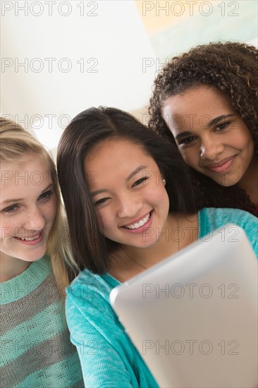 Girls (12-13,14-15,16-17) playing with tablet