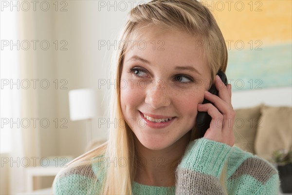Portrait of teenage girl (14-15) with smartphone