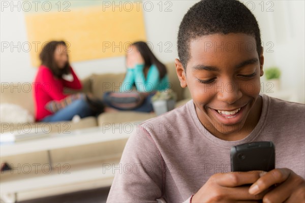 Portrait of teenage boy (14-15) with smartphone