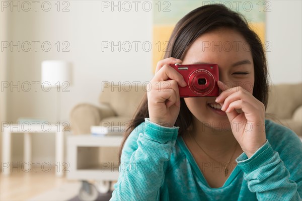 Portrait of teenage girl (16-17) with digital camera