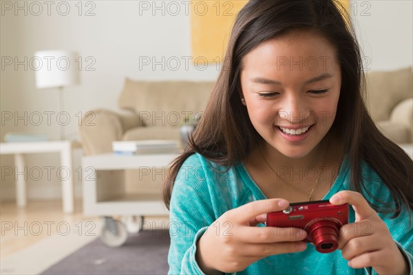 Portrait of teenage girl (16-17) with digital camera