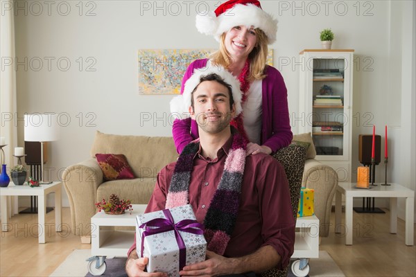 Portrait of young couple wearing santa hats