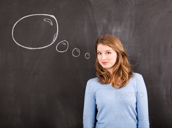 Studio portrait of woman with chalk thought bubble