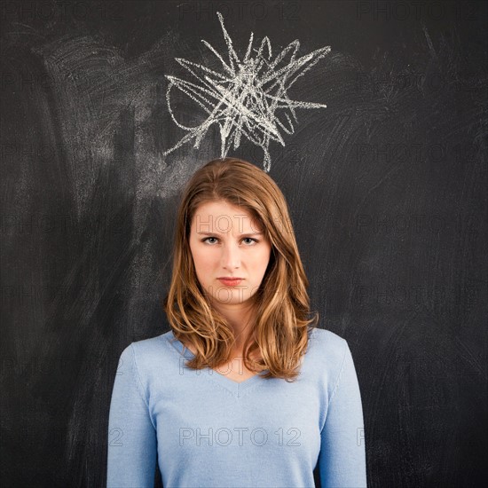 Studio portrait of woman with chalk drawing