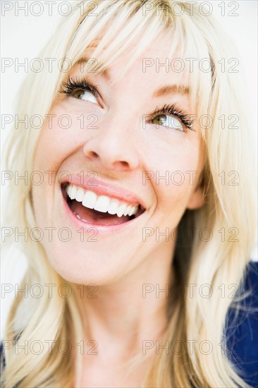 Studio portrait of cheerful blonde woman