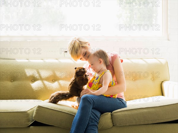 Mother playing with baby daughter (12-17 months)