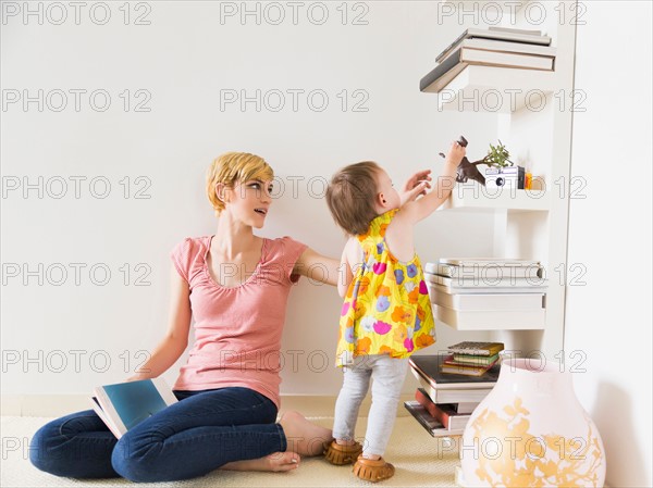 Mother playing with baby daughter (12-17 months)