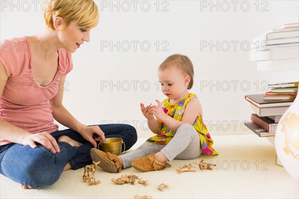 Mother playing with baby daughter (12-17 months)