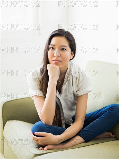 Portrait of woman sitting on sofa