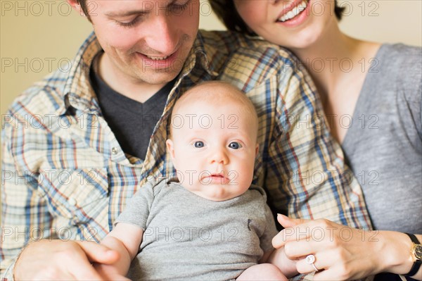 Portrait of parents with baby son (2-5 months)