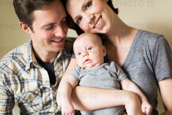 Portrait of parents with baby son (2-5 months)