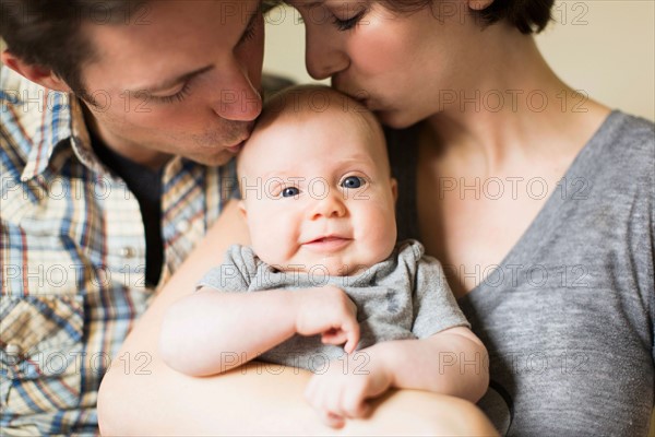 Portrait of parents with baby son (2-5 months)