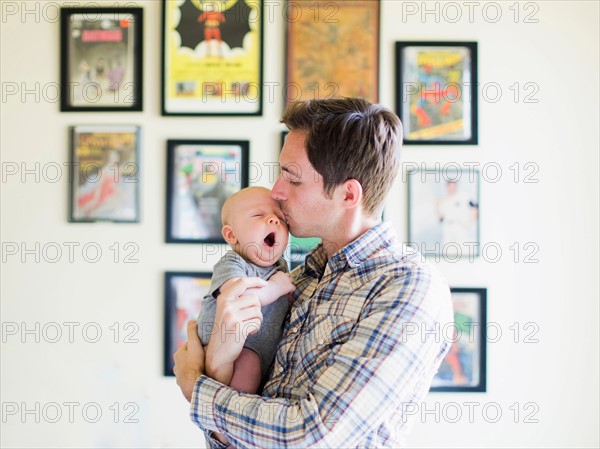 Father kissing baby son (2-5 months)