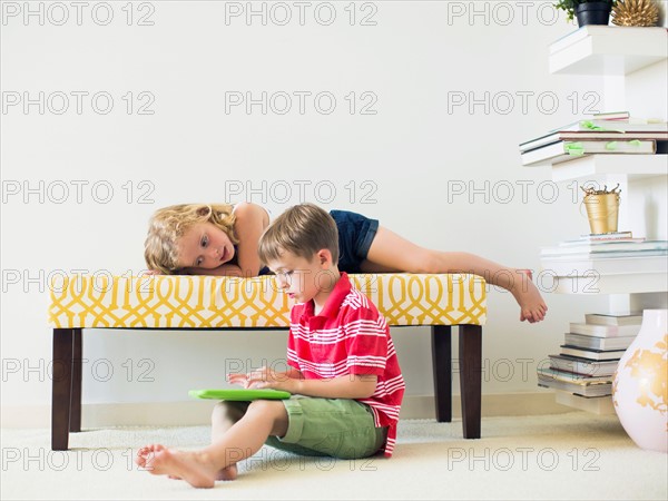 Kids (4-5, 6-7) using digital tablet indoors