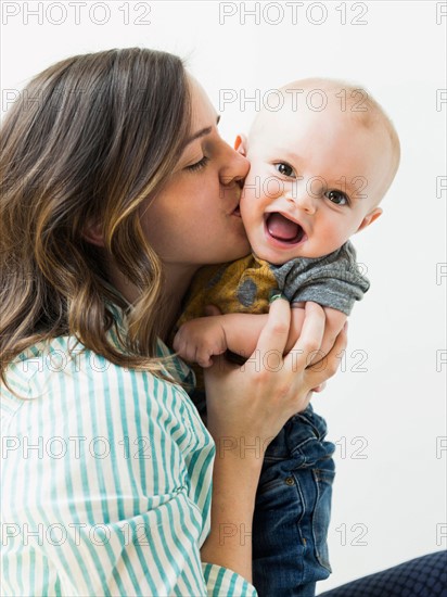 Studio portrait of mother holding baby boy (6-11 months)