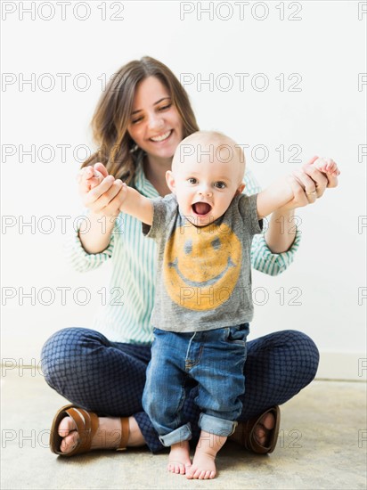 Studio portrait of mother holding baby boy (6-11 months)