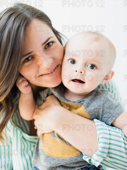 Studio portrait of mother holding baby boy (6-11 months)