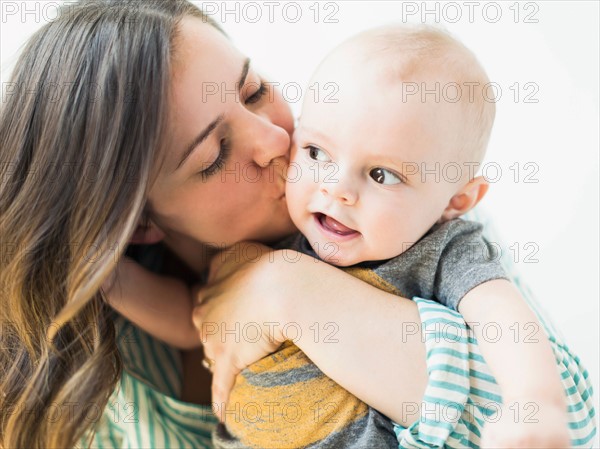 Studio portrait of mother holding baby boy (6-11 months)