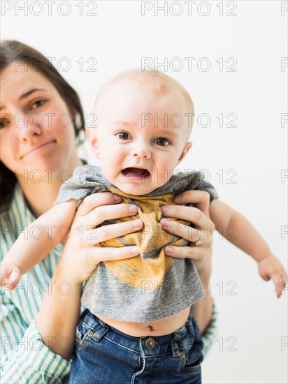 Studio portrait of mother holding baby boy (6-11 months)