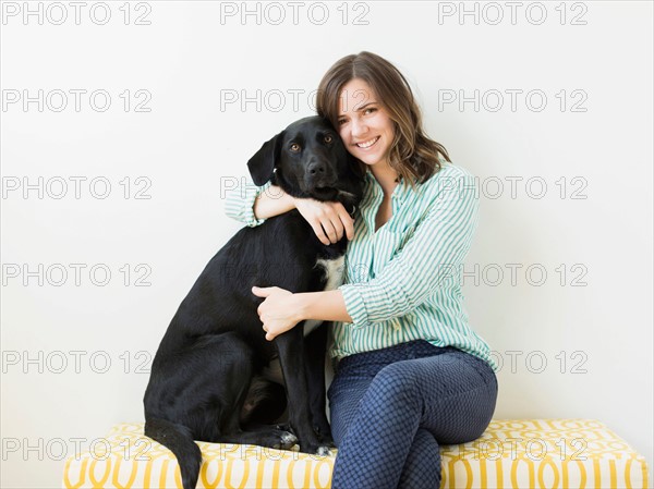 Portrait of woman with black dog