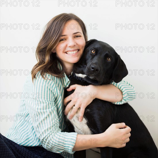 Portrait of woman with black dog