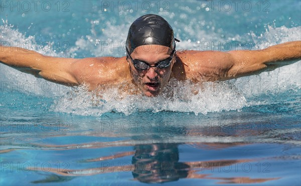 Athletic man swimming.