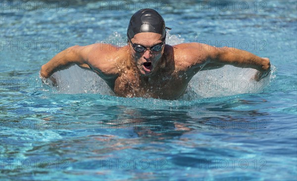 Athletic man swimming.