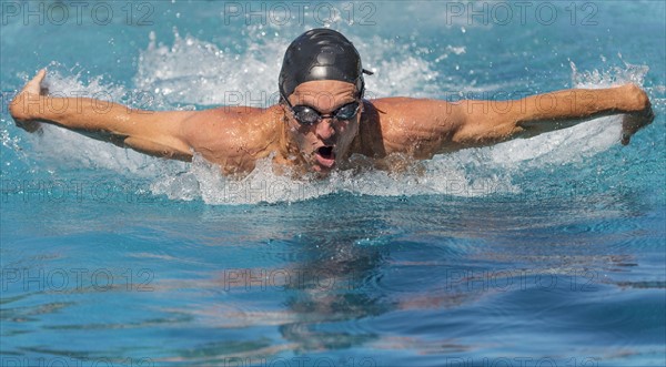 Athletic man swimming.