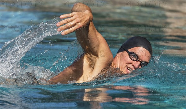 Athletic man swimming.