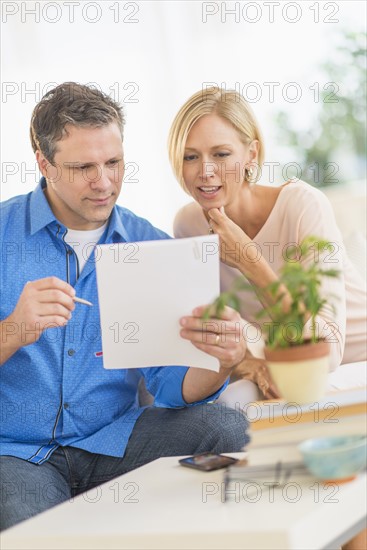 Couple doing paperwork at home.