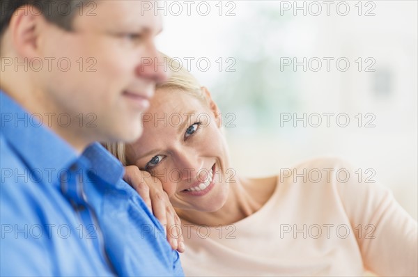 Couple relaxing, focus on woman.