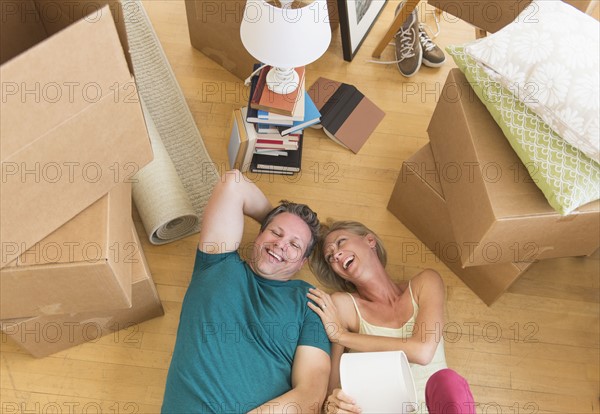 Couple lying on floor of new home.