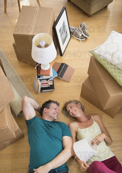 Couple lying on floor of new home.