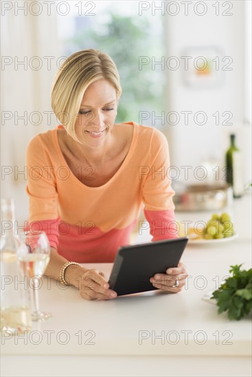 Woman using tablet pc at home.