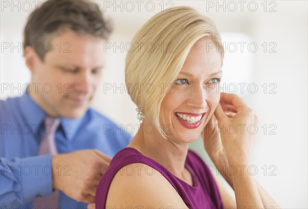 Couple in evening wear, focus on woman.