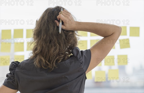Business woman arranging yellow notes.