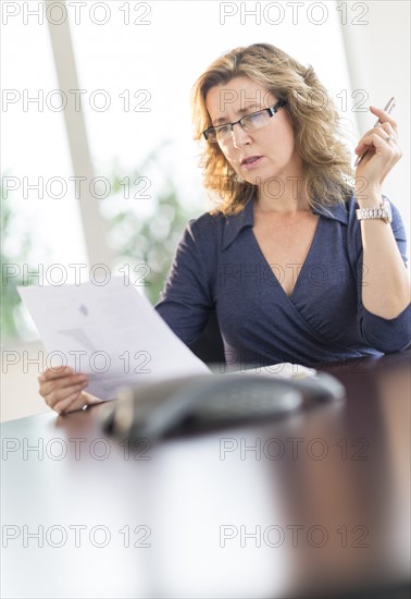 Business woman reading document.