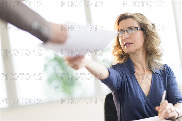 Business people exchanging documents.