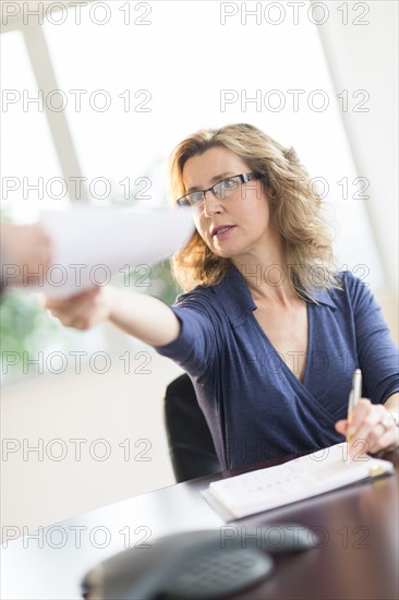 Business people exchanging documents.