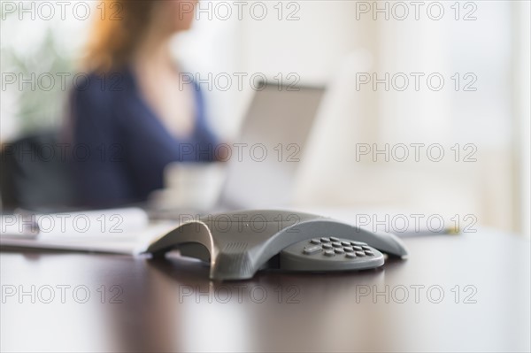 Business phone on office desk.