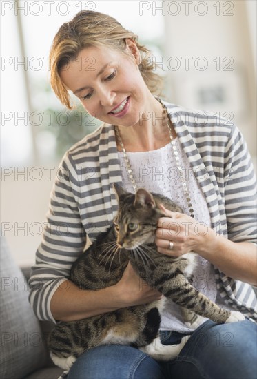 Portrait of woman holding cat.