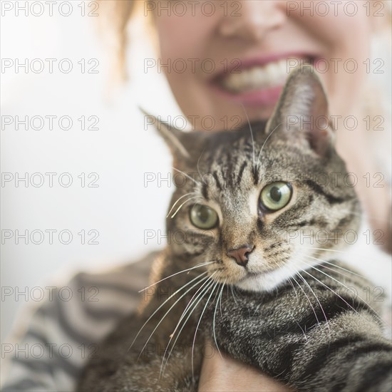 Cat held by woman.