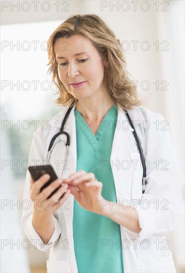 Female doctor using phone.