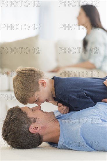 Father with son (6-7) playing at home.